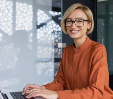 Middle aged businesswoman using laptop while working from home
