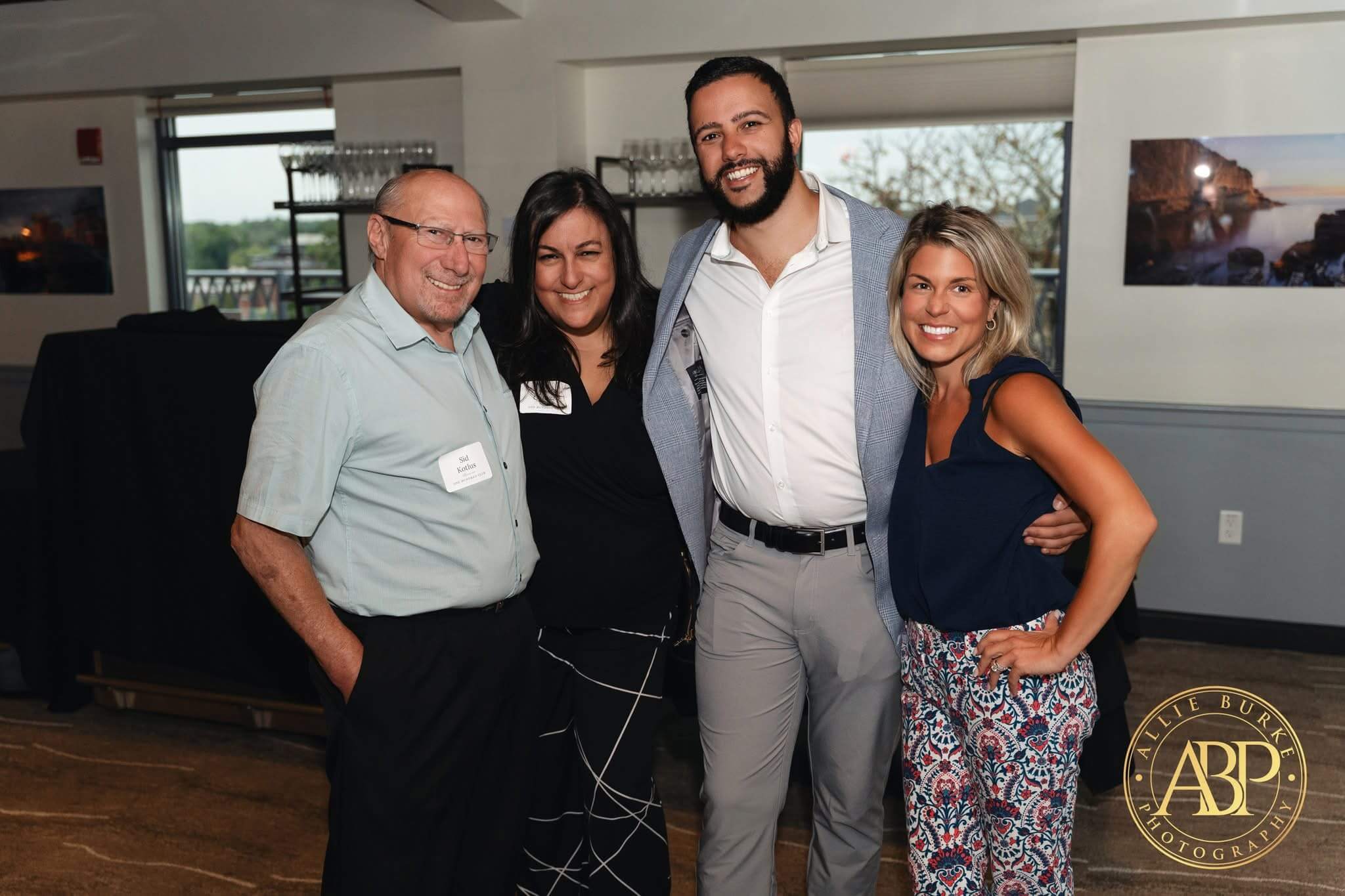 Sid Kotlus photogrpahed with a man and 2 women at an event