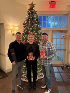 employees in front of a christmas tree